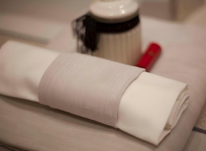 Rolled napkin showing its finished edge