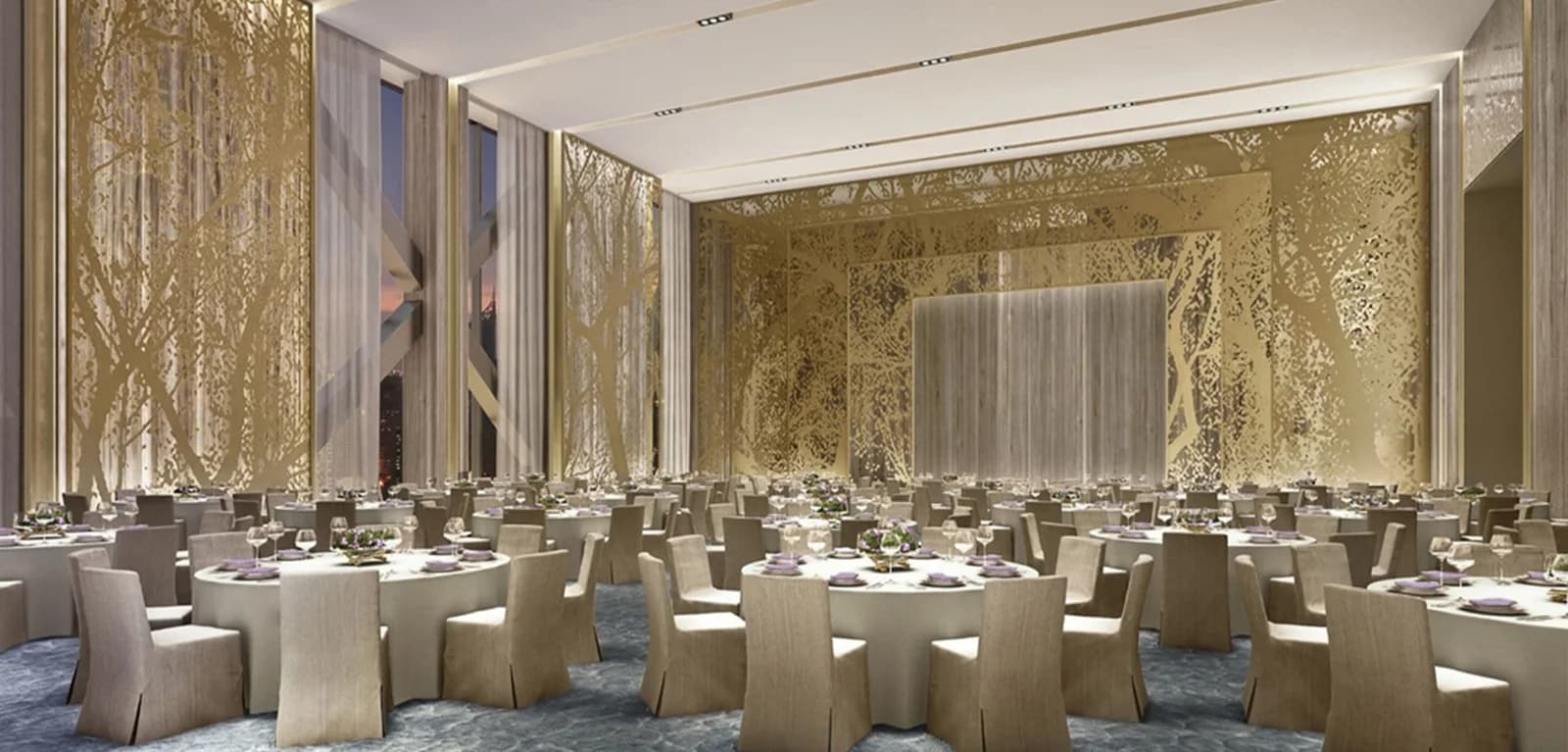 Round banquet tables with light-colored draped tablecloths and coordinated chairs