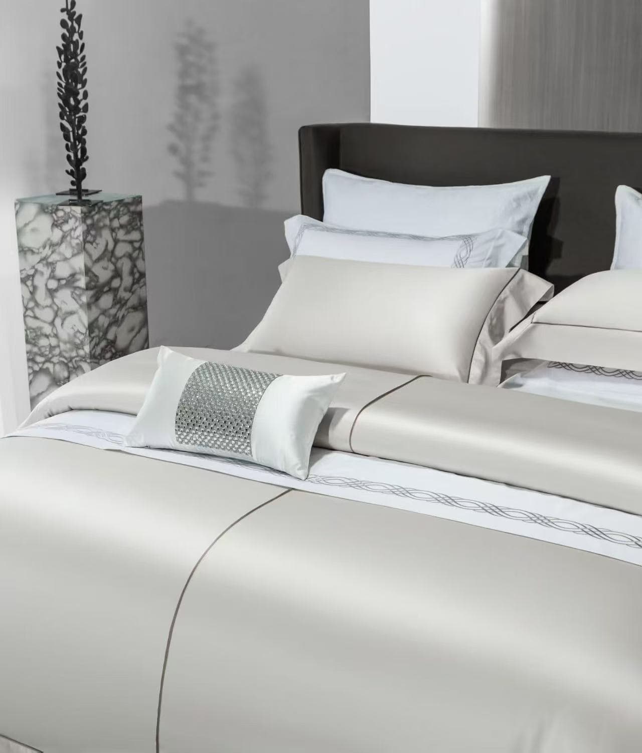 Layered hotel bedding and decorative pillow detail