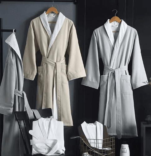 White and grey hotel bathrobes displayed together