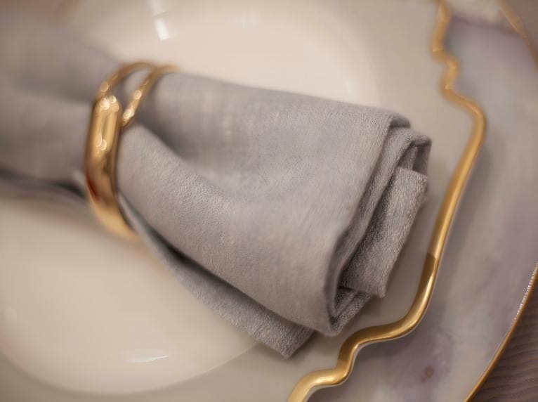 Folded grey napkin in a place setting