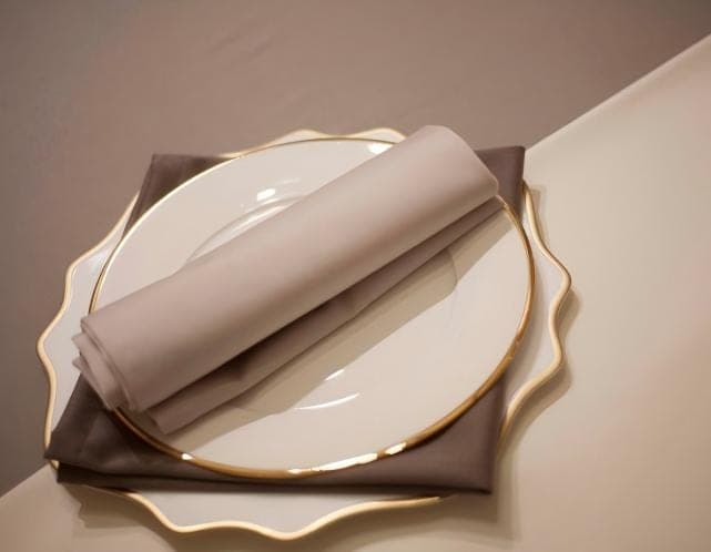 Folded neutral napkin on a dining plate