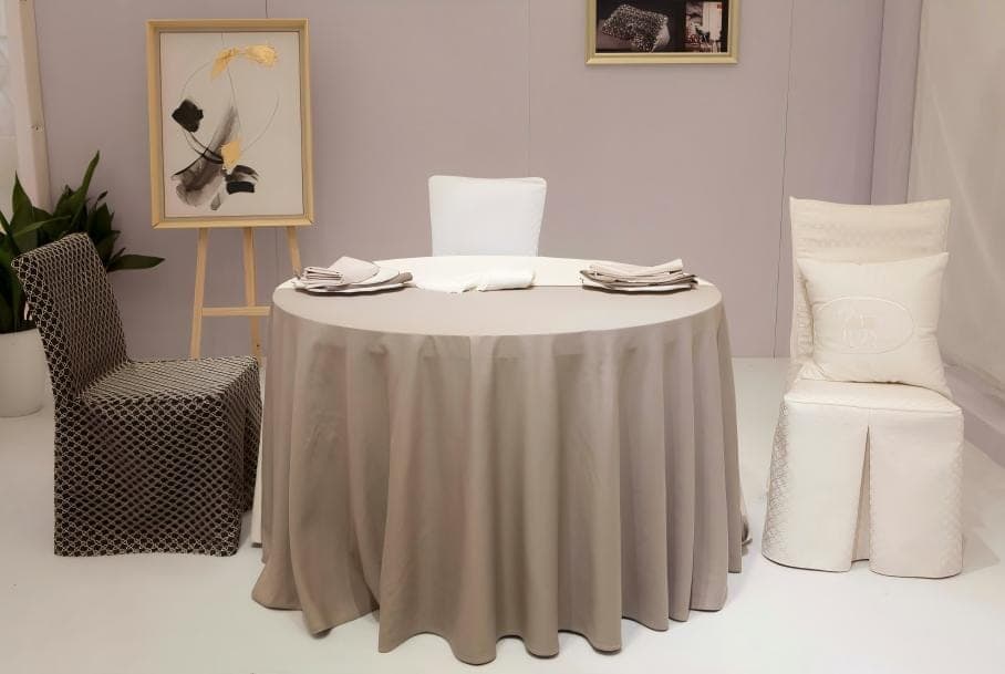 Round table dressed with a neutral tablecloth