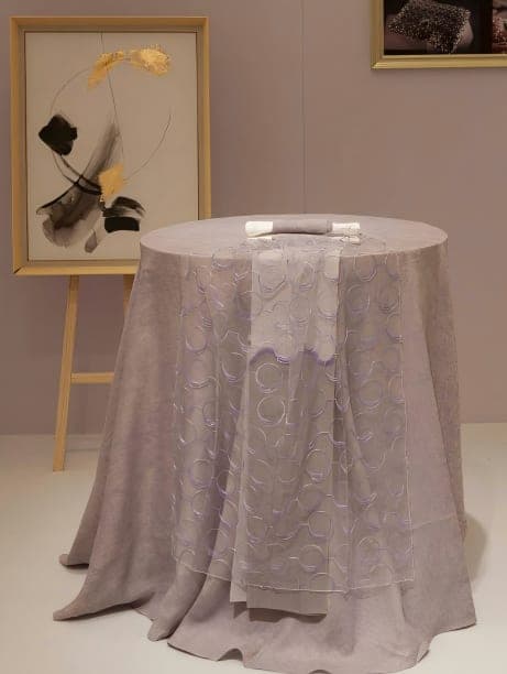 Patterned cloth draped over a round table